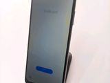 the back of a phone with a blue button on the display