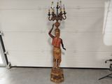 an image of a statue of a man holding a candelabra