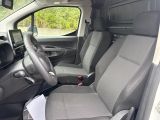 the interior of a small van with two seats and a steering wheel