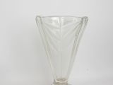 a glass vase that is sitting on a white surface