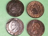 four different types of coins are shown on a green surface