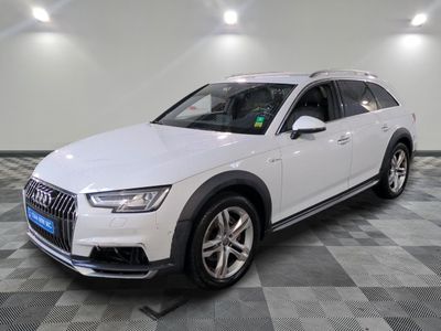the white audi suv is parked on a checkered tile floor