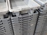 many plastic containers stacked on a pallet in a warehouse