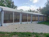 a large white tent that is set up in the grass
