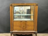 a wooden display cabinet with a glass door on top