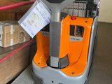 a forklift that is sitting next to some boxes