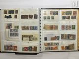 an open book with stamps on it on a table