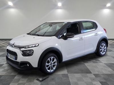 the white citrole is parked on a checkered tile floor