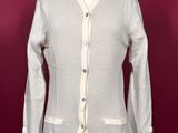 the jacket is white and has buttons on the front