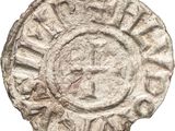 a close up of a coin with a cross on it