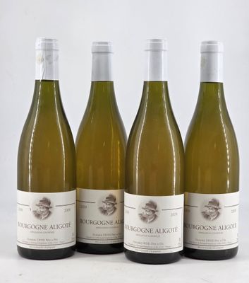 three bottles of white wine are lined up on a table
