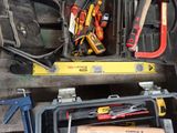 many tools in a toolbox on a wooden table