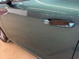 a close up of a car door handle with a sticker on it
