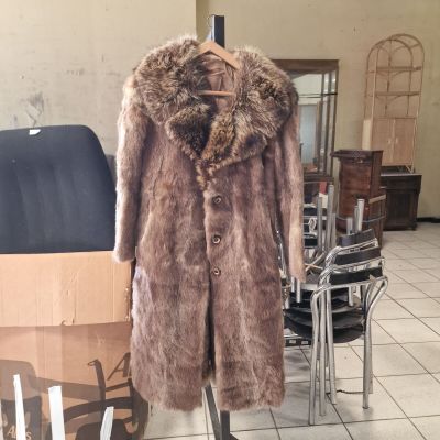 a fur coat on a mannequin stand in a room