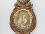an antique picture of a woman holding a child in a gold frame