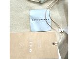 the label on the back of a dress is attached to a tag