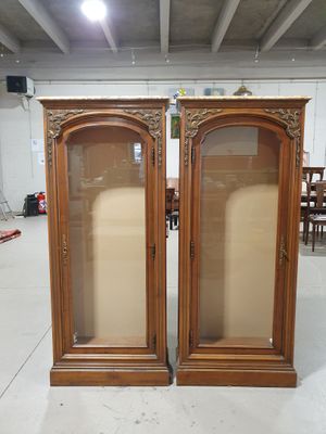 pair of antique wooden display cabinets with glass doors
