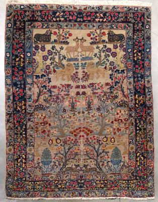 an antique persian rug with a floral design on a blue ground