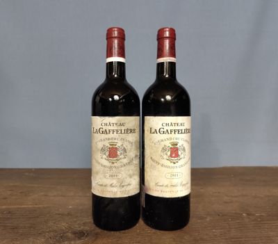 two bottles of wine sitting on a wooden table