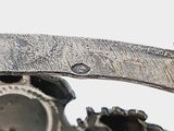 a close up of a piece of metal with gears attached to it