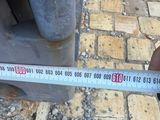 someone is measuring the height of a parking meter on the sidewalk