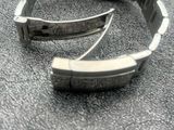 a watch that is laying on the floor next to a cell phone