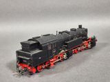 an image of a black and red train engine on a gray surface