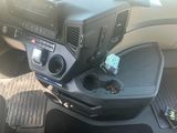 a car dashboard with a cup holder in the center