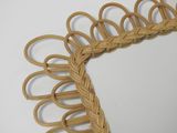 a picture of a wicker mirror with a decorative frame