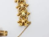 a gold necklace with a cross on it and a cross on the chain