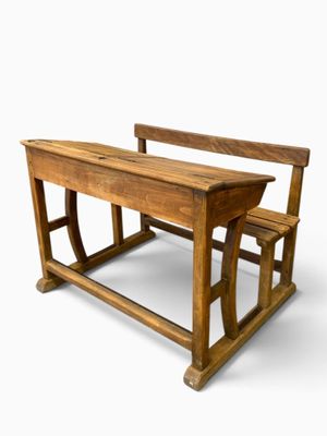 a wooden school desk and a chair on a white background