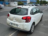 a white car that is parked on the side of the road