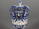a blue and white vase with a spoon in it