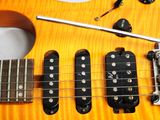 a close up of an electric guitar with a pick up