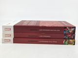 three books are stacked on top of each other on a white surface