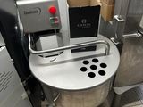 a machine that is sitting on the floor in a kitchen