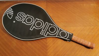an image of a tennis racket sitting on top of a wooden table