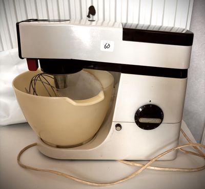a mixer that is sitting on a counter next to a bowl