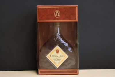 a bottle of liquor sitting in a box on a table