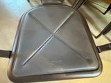 a metal chair with a seat that has a triangle design on it