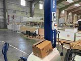 an image of a forklift in a warehouse with boxes on it