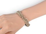 an image of a woman ' s hand with a bracelet on it