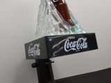 a bottle of coke on top of a box on a table