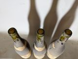 three bottles of wine that are sitting on a table