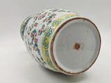 a white vase with a floral design on it
