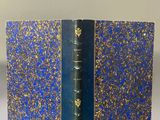 a close up of a book with a blue cover on a table