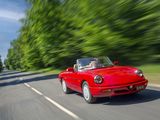 the red sports car is driving down the road near the trees