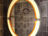 a round mirror on the wall in a bathroom