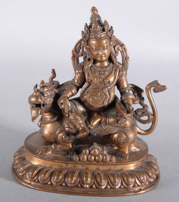 statue en laiton représentant une femme assise sur un lion, tenant un pot