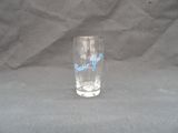 a glass with a blue writing on it on a gray background